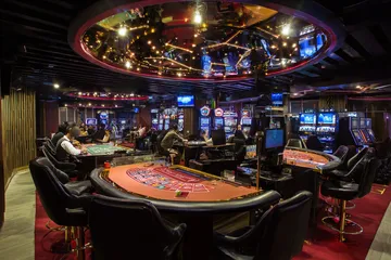 BAJI200 Casino Games — Enjoy nonstop entertainment A close-up shot of golden coins falling around a spinning roulette wheel, representing immersive casino action at BAJI200.